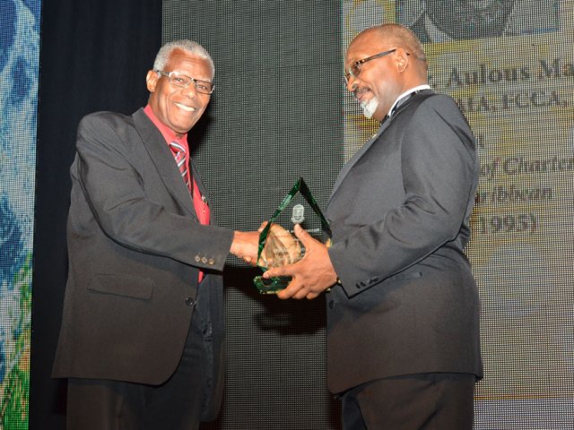 Aulous Madden accepts ICAC Recognition Award at the 33rd Caribbean Annual Conference on June 26, 2015